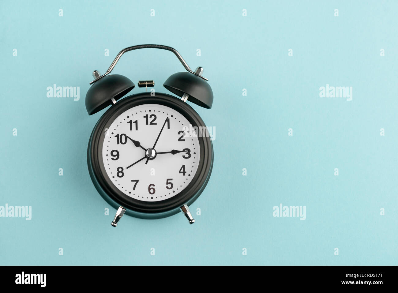 Vintage alarm clock on blue Stock Photo - Alamy