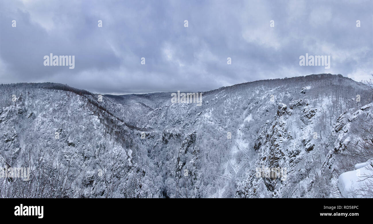 a high resolution panorama view of the vast Bode river Valley in the Harz mountains of central Germany during winter Stock Photo