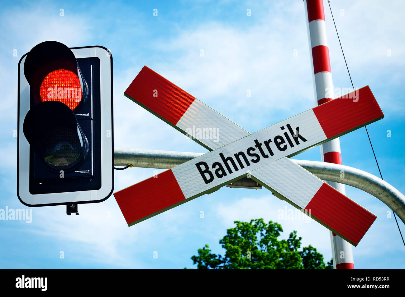 Level crossing with St Andrew's Cross and label Road strike, Photomontage, Bahnübergang mit Andreaskreuz und Aufschrift Bahnstreik, Fotomontage Stock Photo
