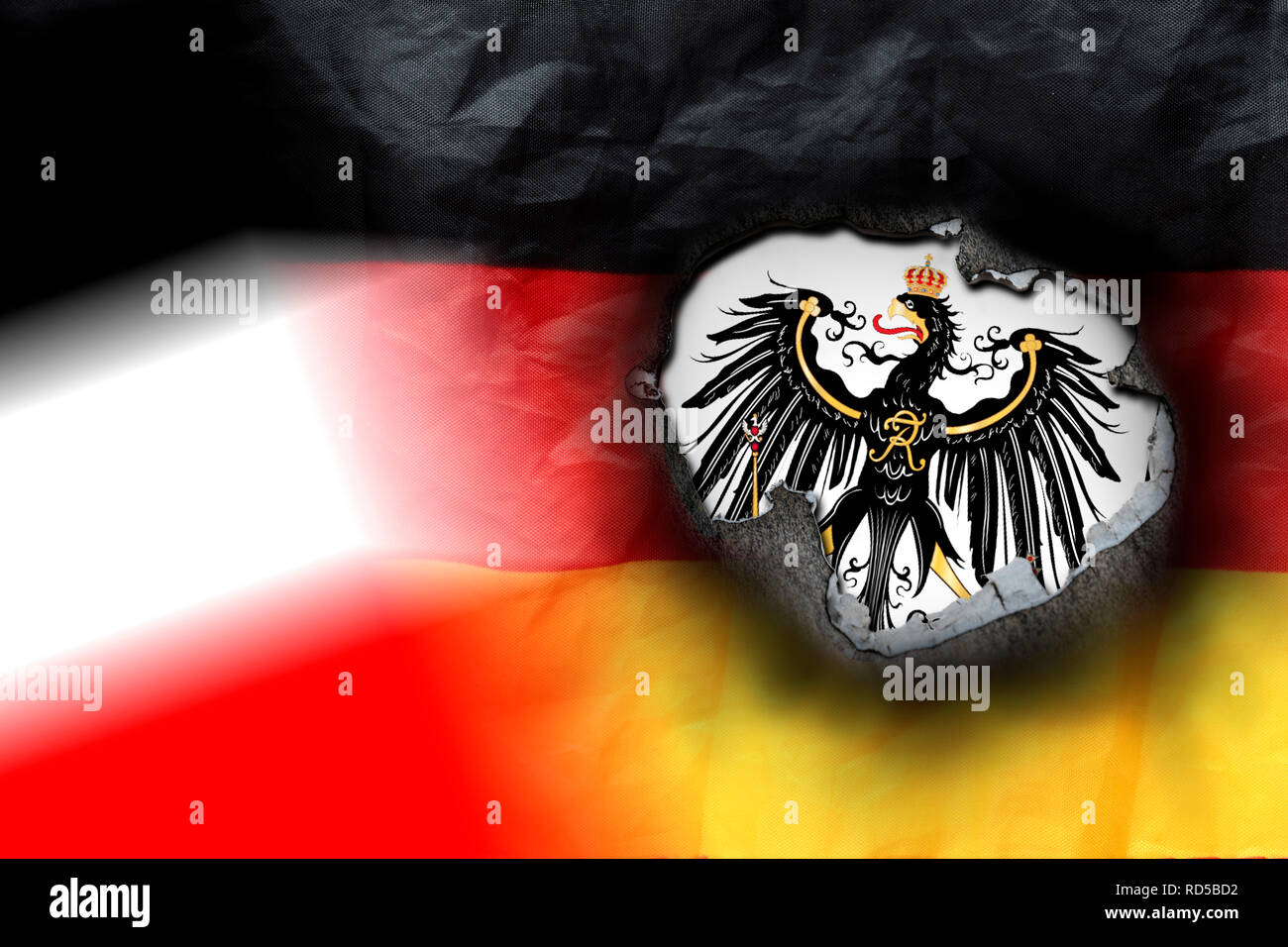 Germany flag with fire hole and imperial eagle, symbolic photo imperial citizen's movement, Deutschlandfahne mit Brandloch und Reichsadler, Symbolfoto Stock Photo