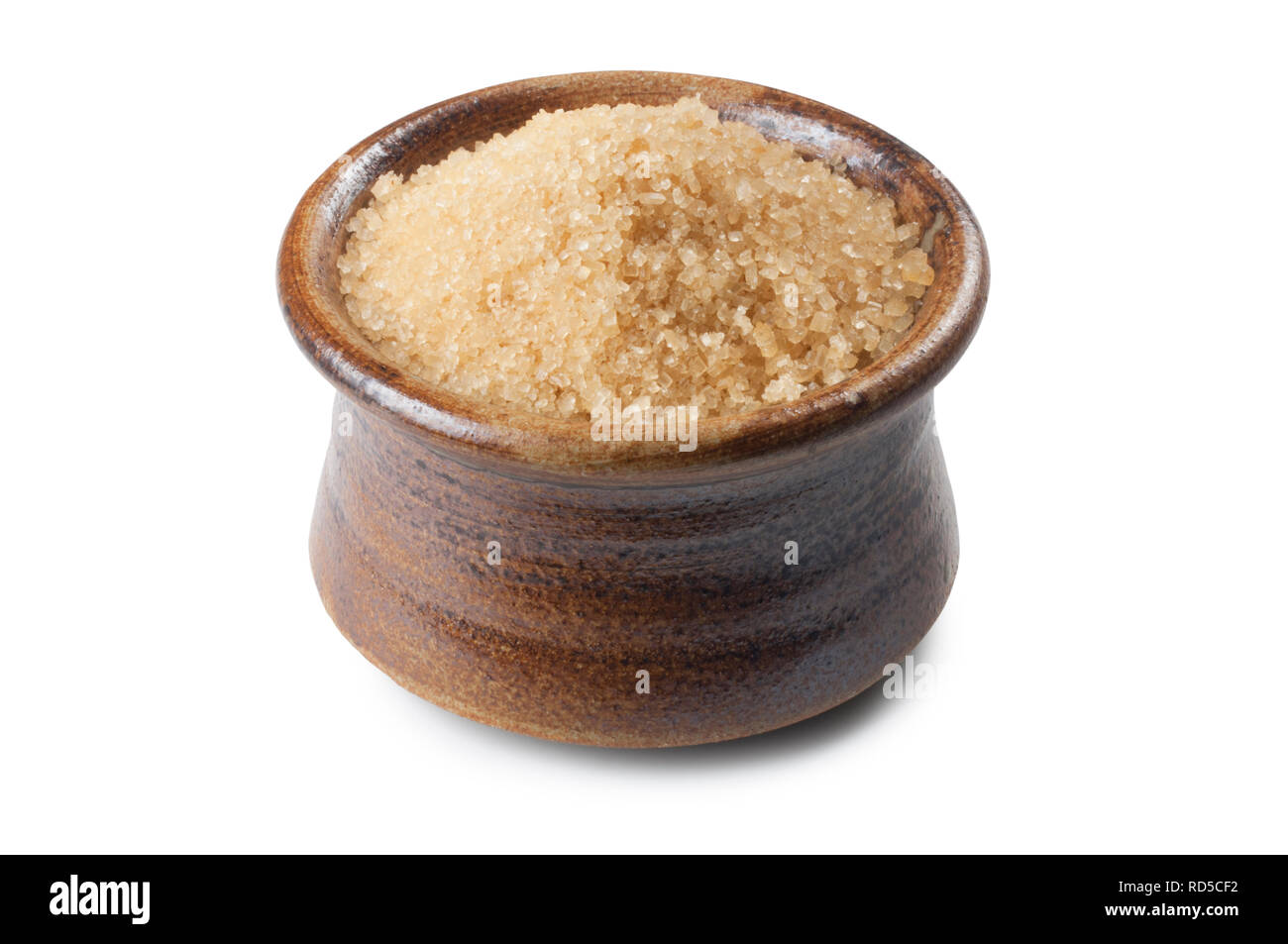 Studio shot of a pot of brown sugar isolated on white background - John Gollop Stock Photo