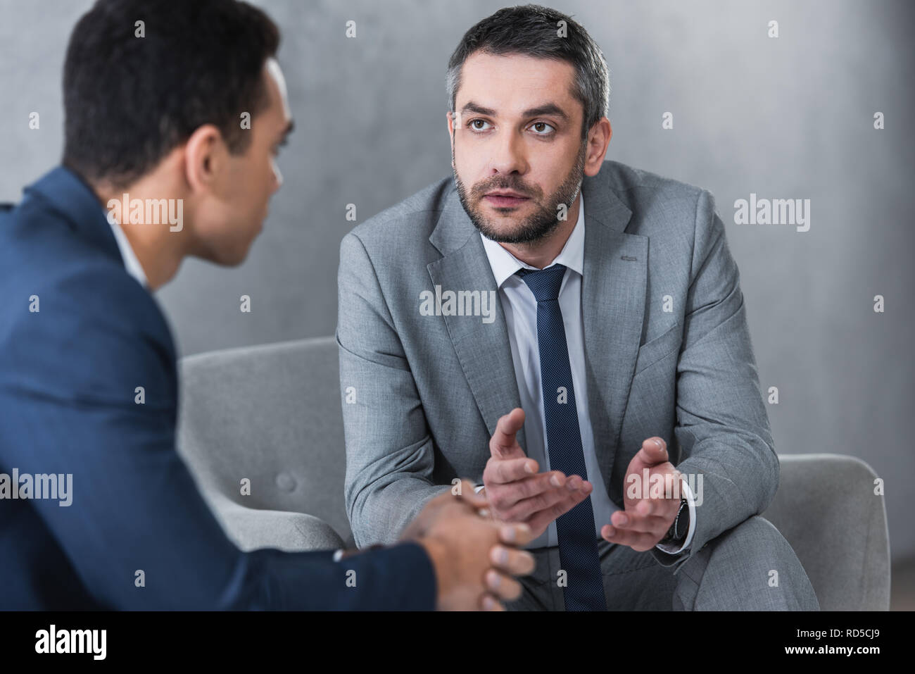 Two colleagues in suits talking hi-res stock photography and images - Alamy