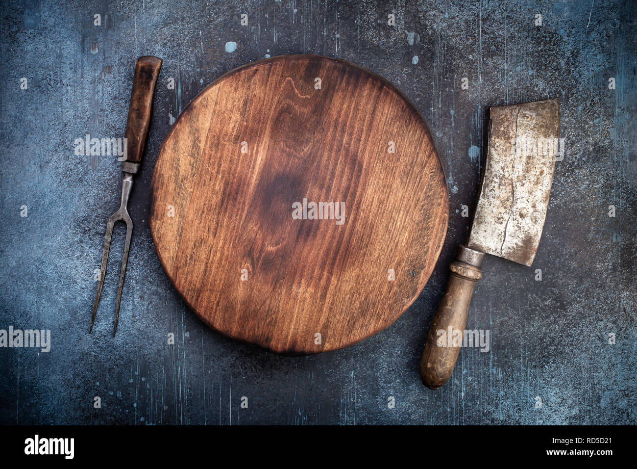 Cutting board with meat cleaver and fork Stock Photo Alamy