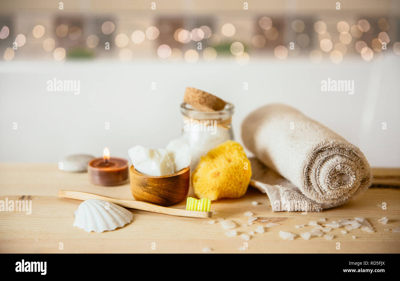 Using natural material products in home, different eco friendly cosmetic products in bathroom. Minimizing ecological footprint concept. Bamboo bath to Stock Photo