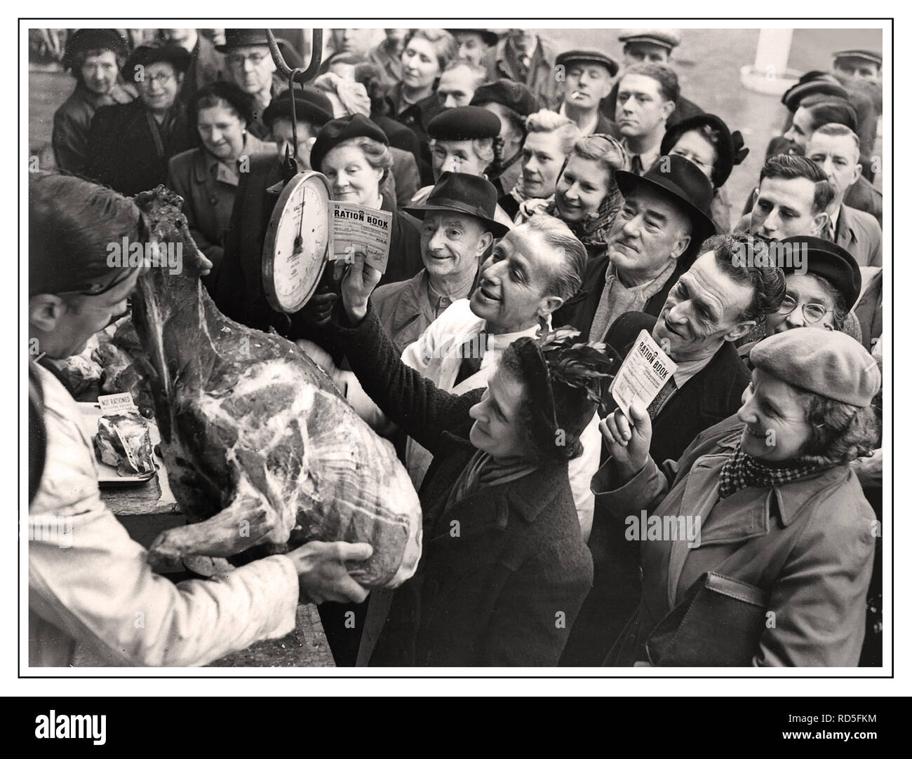 MEAT RATIONING Post-War 1946 WW2 British propaganda image of happy food-shopping crowd with government food ration books keen to purchase un-rationed Reindeer Meat from Smithfield Market Butcher London UK Stock Photo