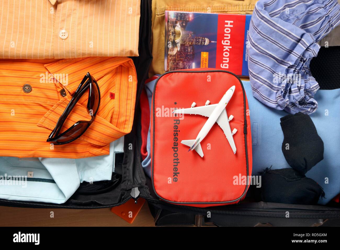Holiday luggage, first-aid kit, travel guides, sunglasses Stock Photo