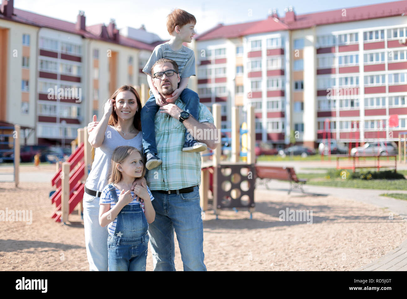 young family standing on the Playground Stock Photo - Alamy