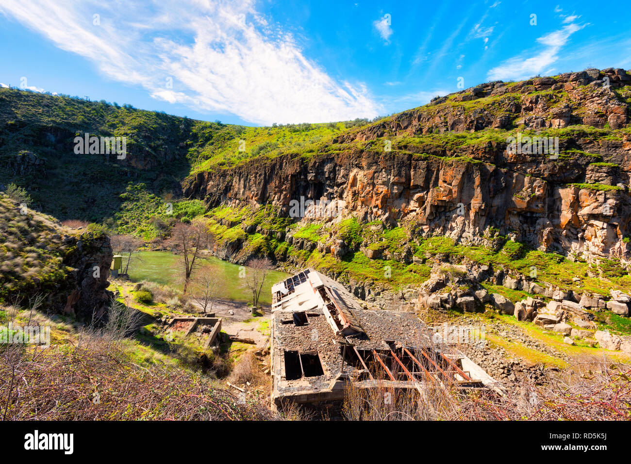 Looking down at White River is a wild and scenic river canyon where an decaying hydropower plant sits, built in 1910 and abandoned in 1960. Stock Photo