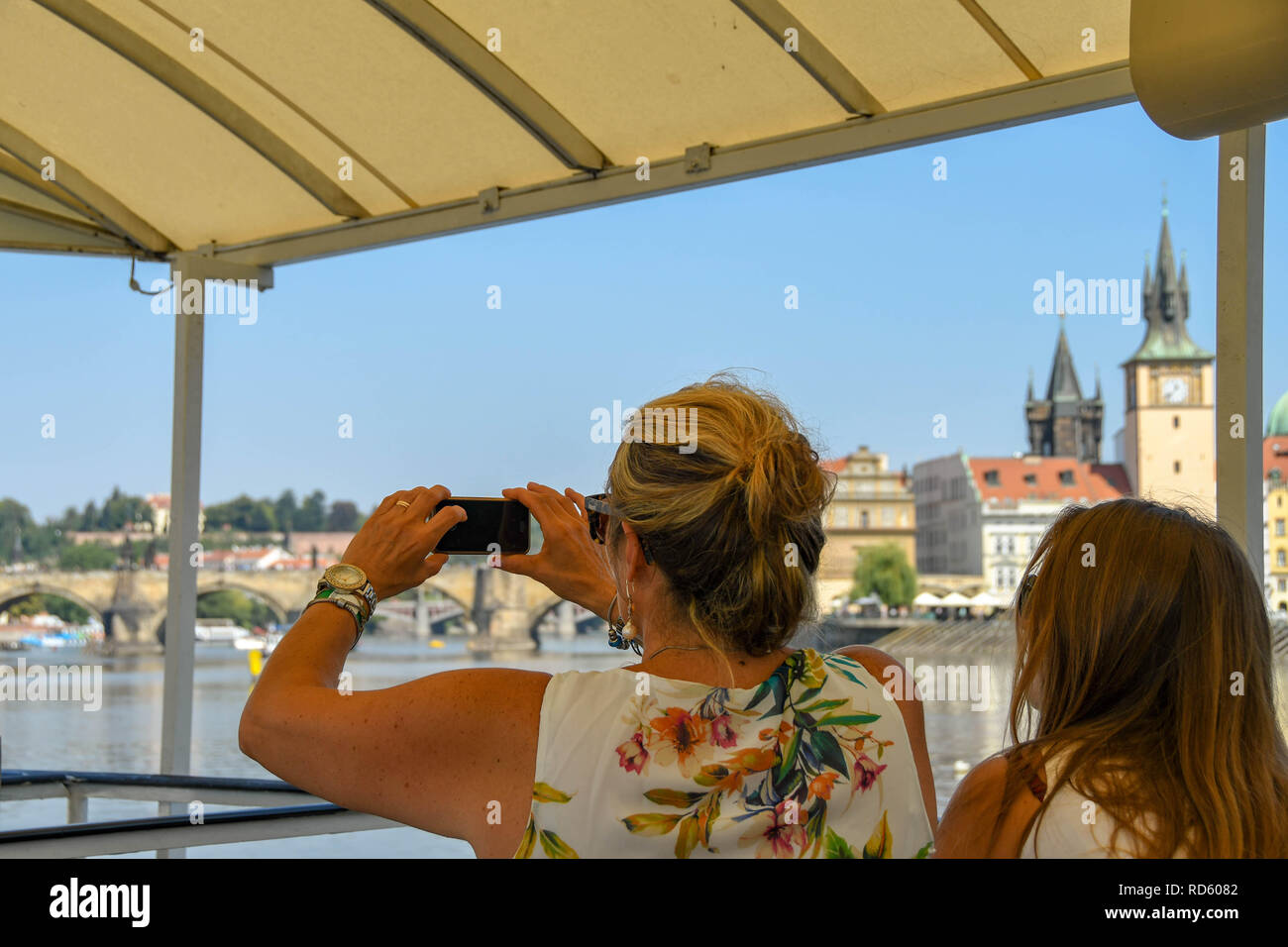 PRAGUE, CZECH REPUBLIC - AUGUST 2018:  Person taking a picture on a river cruise boat  in Prague using a camera phone. Stock Photo