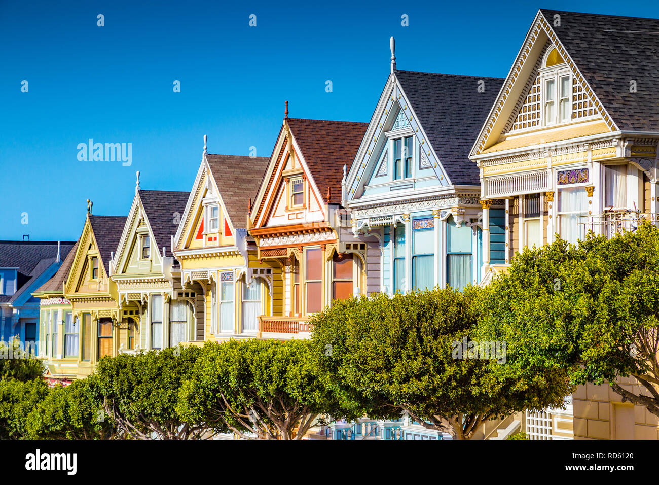 Famous Painted Ladies, a row of colorful Victorian houses located near scenic Alamo Square, on a beautiful sunny day, San Francisco, USA Stock Photo