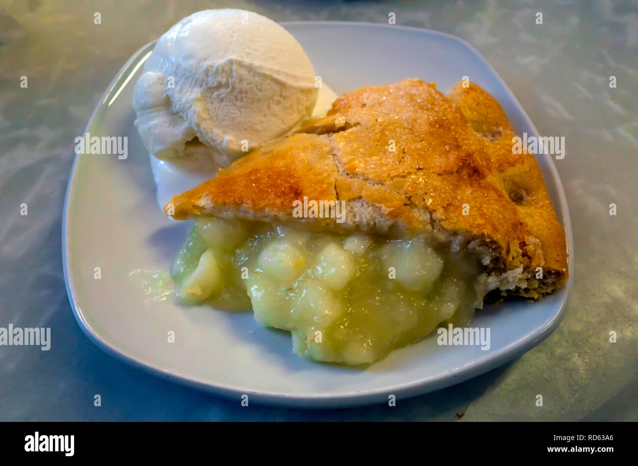 A serving of warm Apple Pie with ice cream in England UK Stock Photo