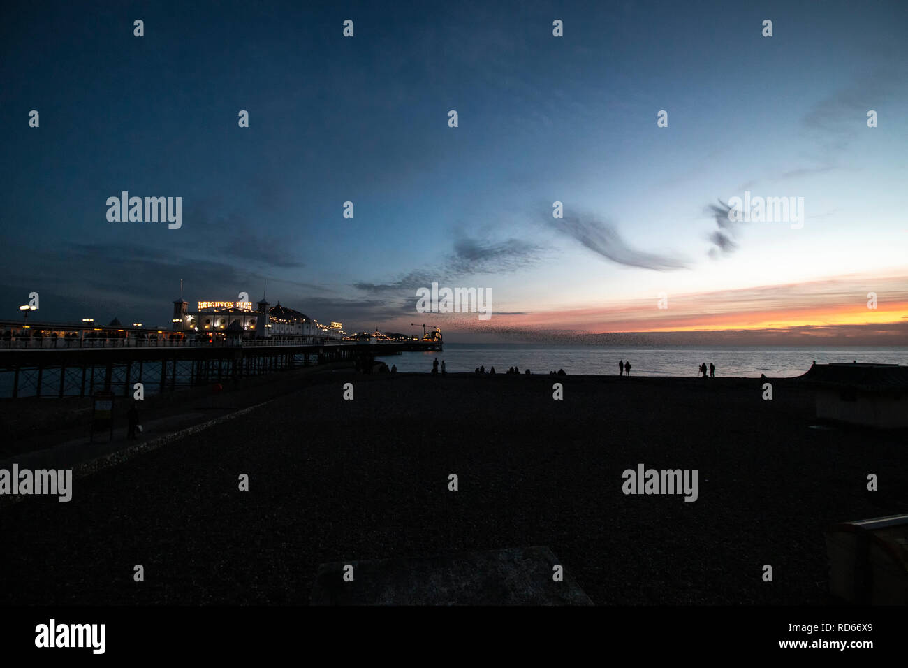 Starling murmuration at Brighton Pier at sunset Stock Photo