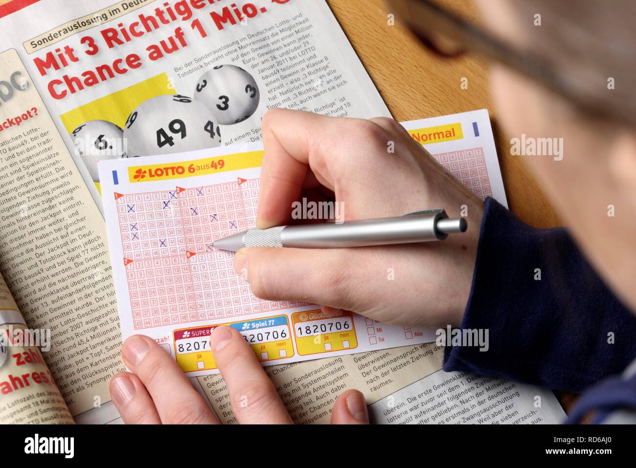 Person filling out a lottery ticket, 6 from 49, ticking off numbers Stock  Photo - Alamy