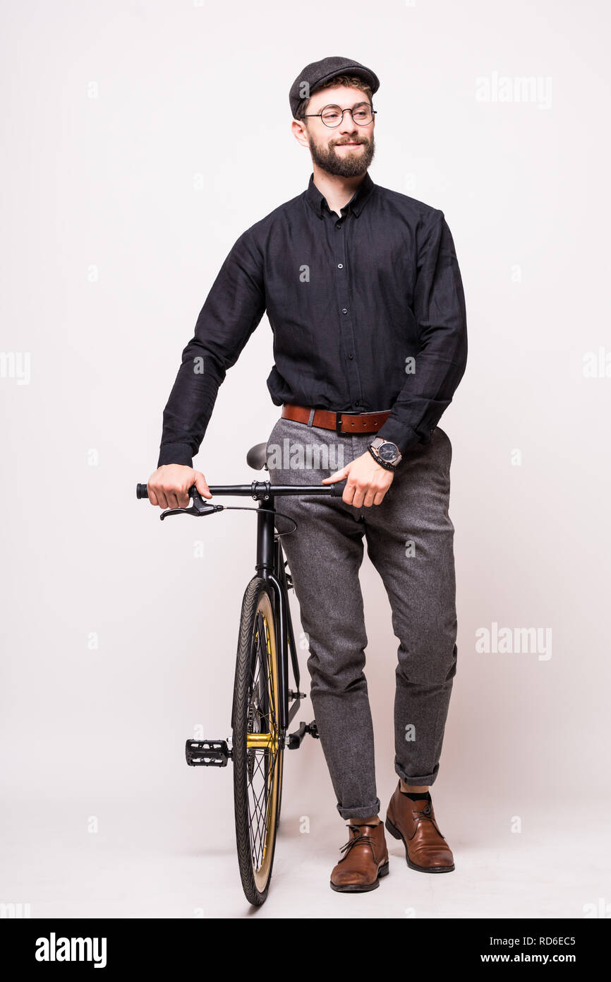 Portrait of a bearded man walking with fixie bicycle over white background Stock Photo