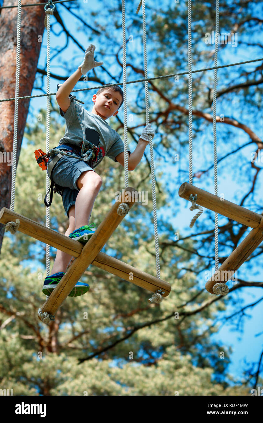 Cute little boy enjoying his time in climbing adventure park Stock Photo