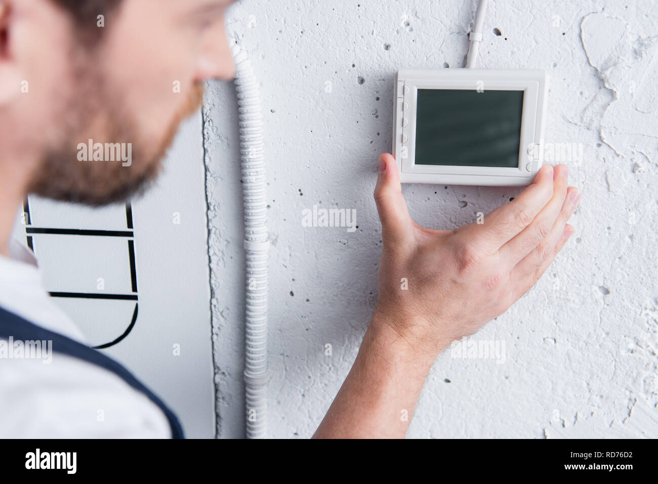 partial view of male handyman checking electrical panel Stock Photo