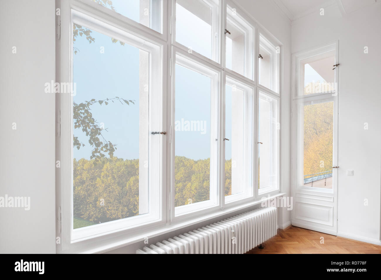 big wooden windows in apartment room of old building Stock Photo