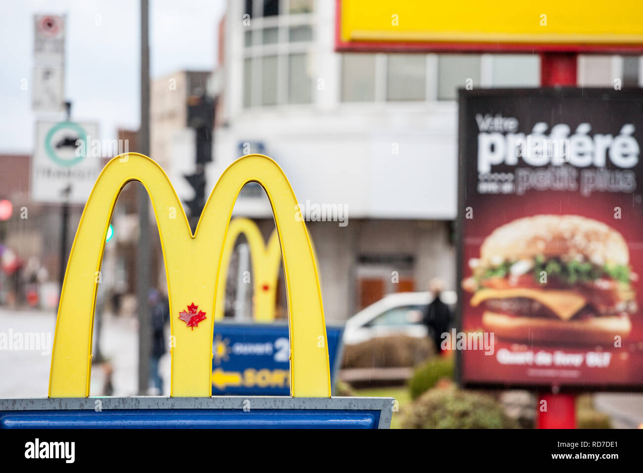 MONTREAL, CANADA - NOVEMBER 6, 2018: Mc Donald's Canada logo with its iconic M in front of a local restaurant, with the Iconic Canadian Maple Leaf in  Stock Photo