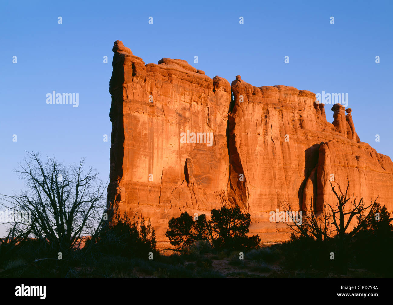 USA, Utah, Arches National Park, Sunrise light on the Tower of Babel which is composed of Entrada Sandstone. Stock Photo
