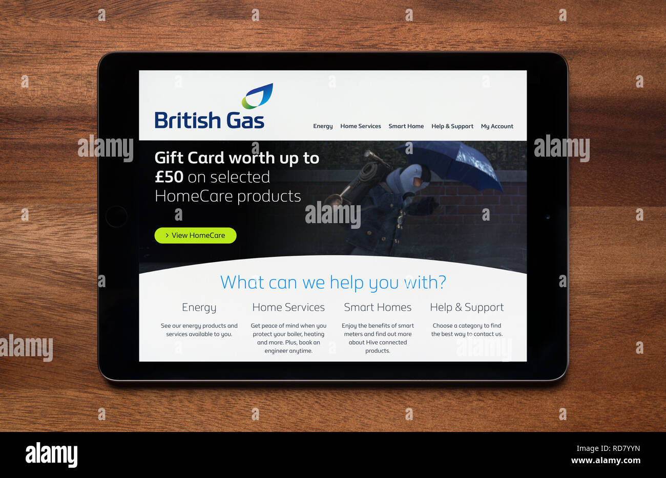 The website of British Gas is seen on an iPad tablet, which is resting on a wooden table (Editorial use only). Stock Photo
