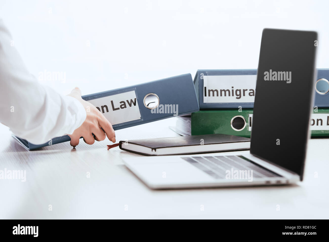Immigration Folder selective focus of woman taking folder with immigration law lettering ...