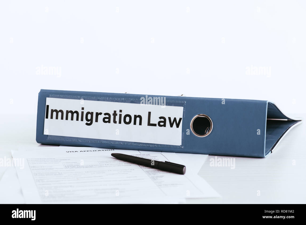 Immigration Folder selective focus of folder with immigration law lettering near documents ...