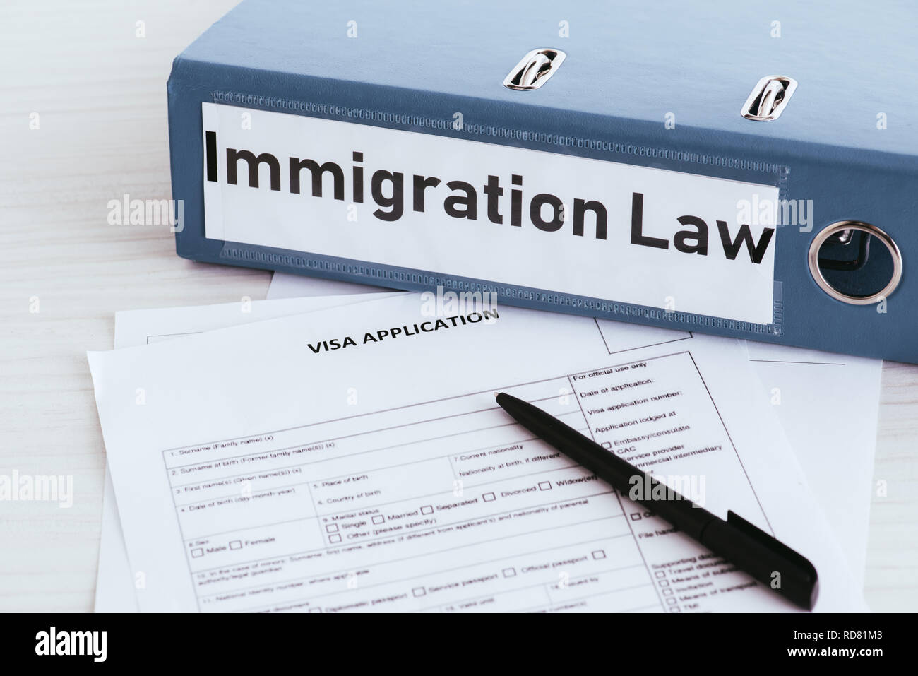Immigration Folder selective focus of folder with immigration law lettering near documents ...