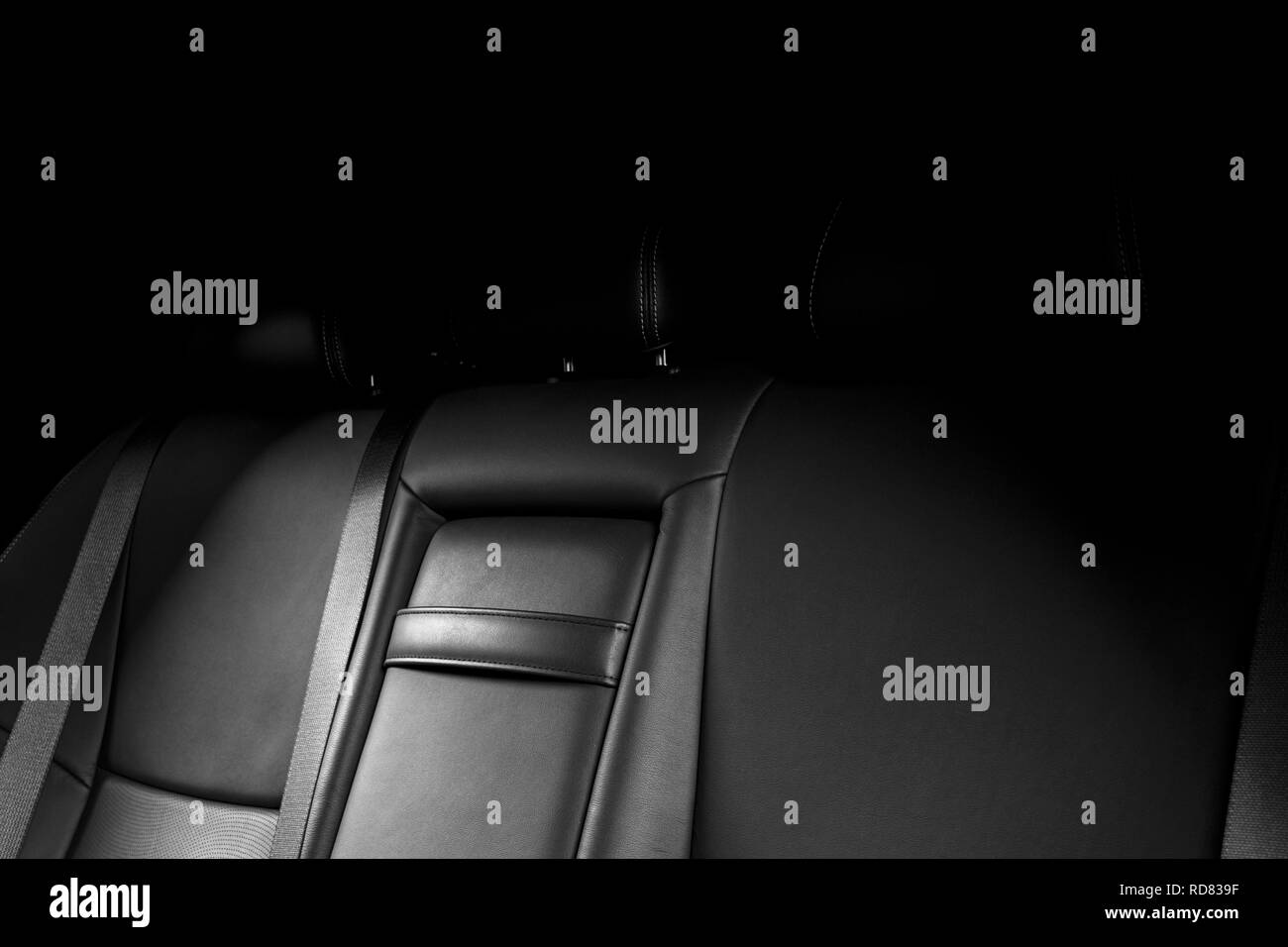 Back passenger seats in modern luxury car, frontal view. Black