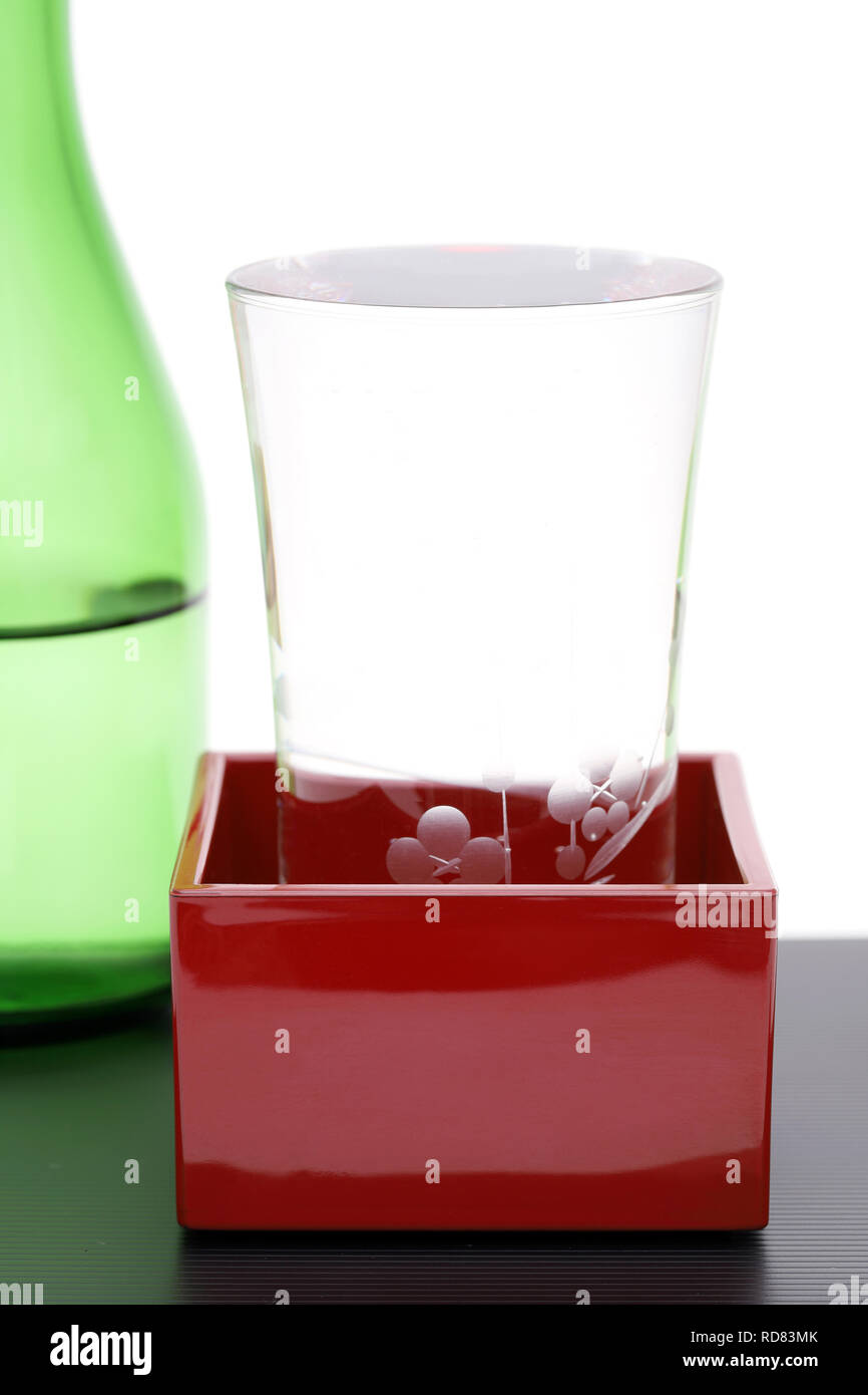 Japanese wooden box masu with sake isolated on white background Stock