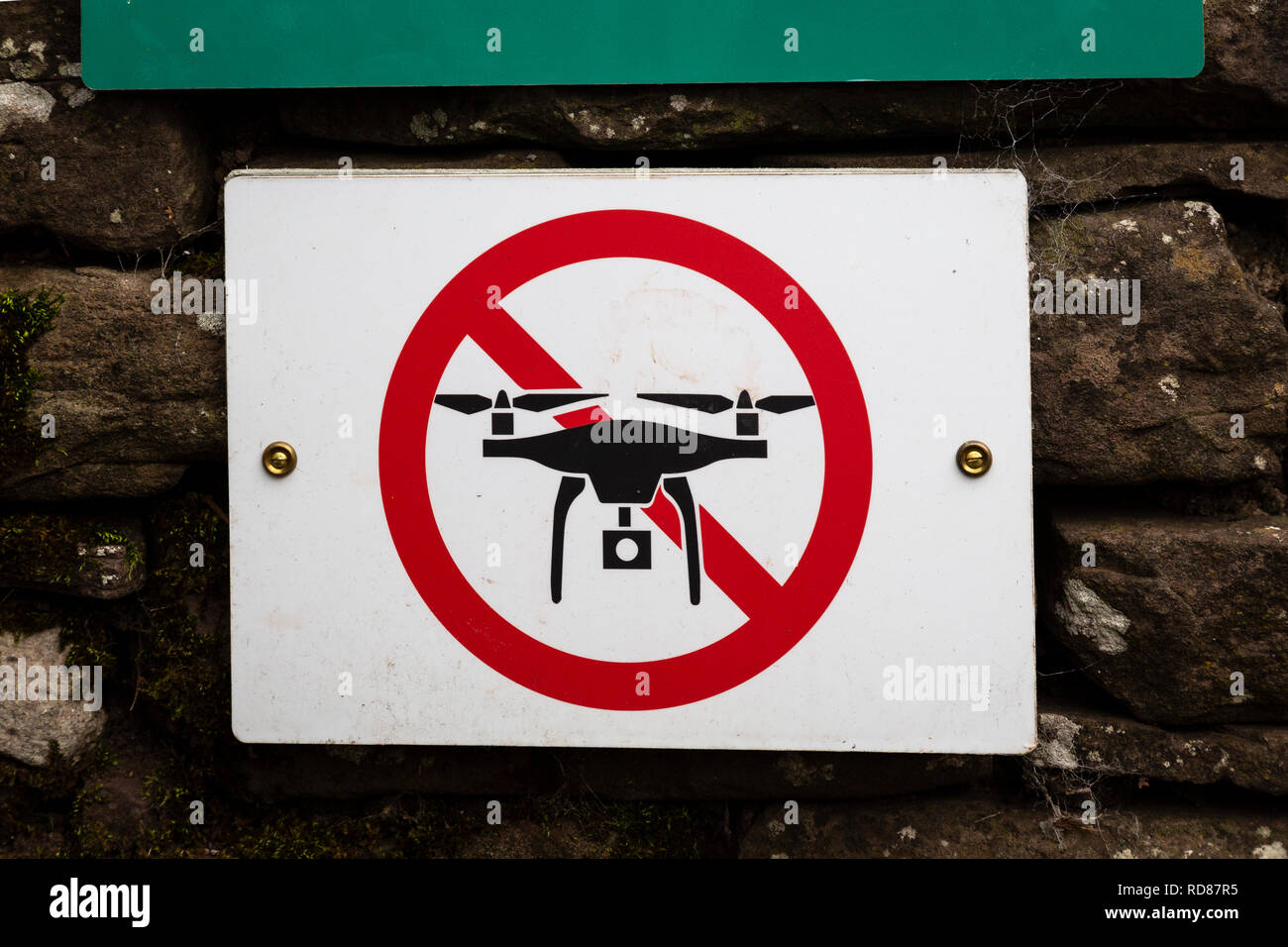 No drones sign on the wall of Llanthony Priory, in the Black Mountains, Brecon Beacons National Park, Monmouthshire, Wales. Stock Photo