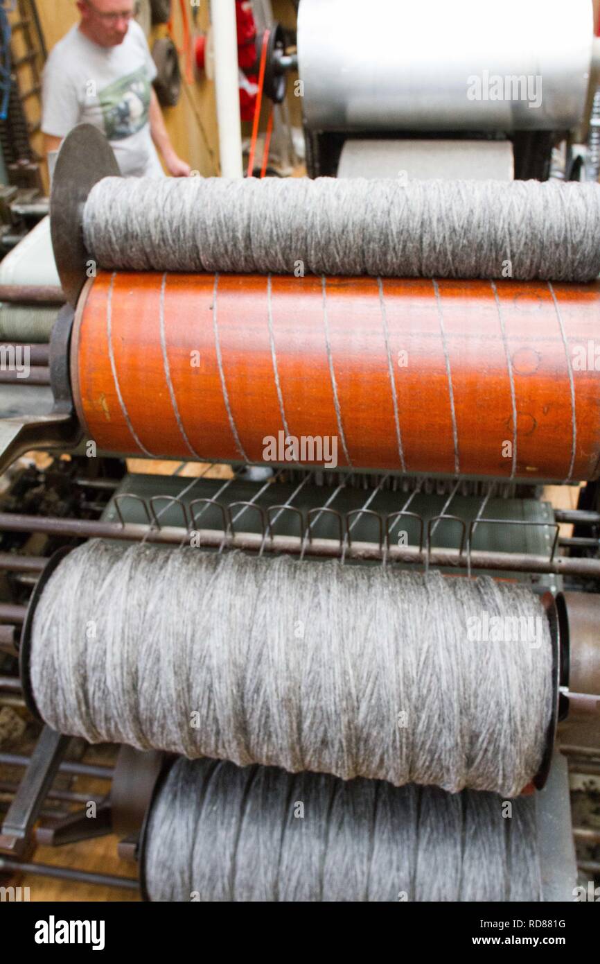 Wool thread being spun from raw wool product , part of process to ...