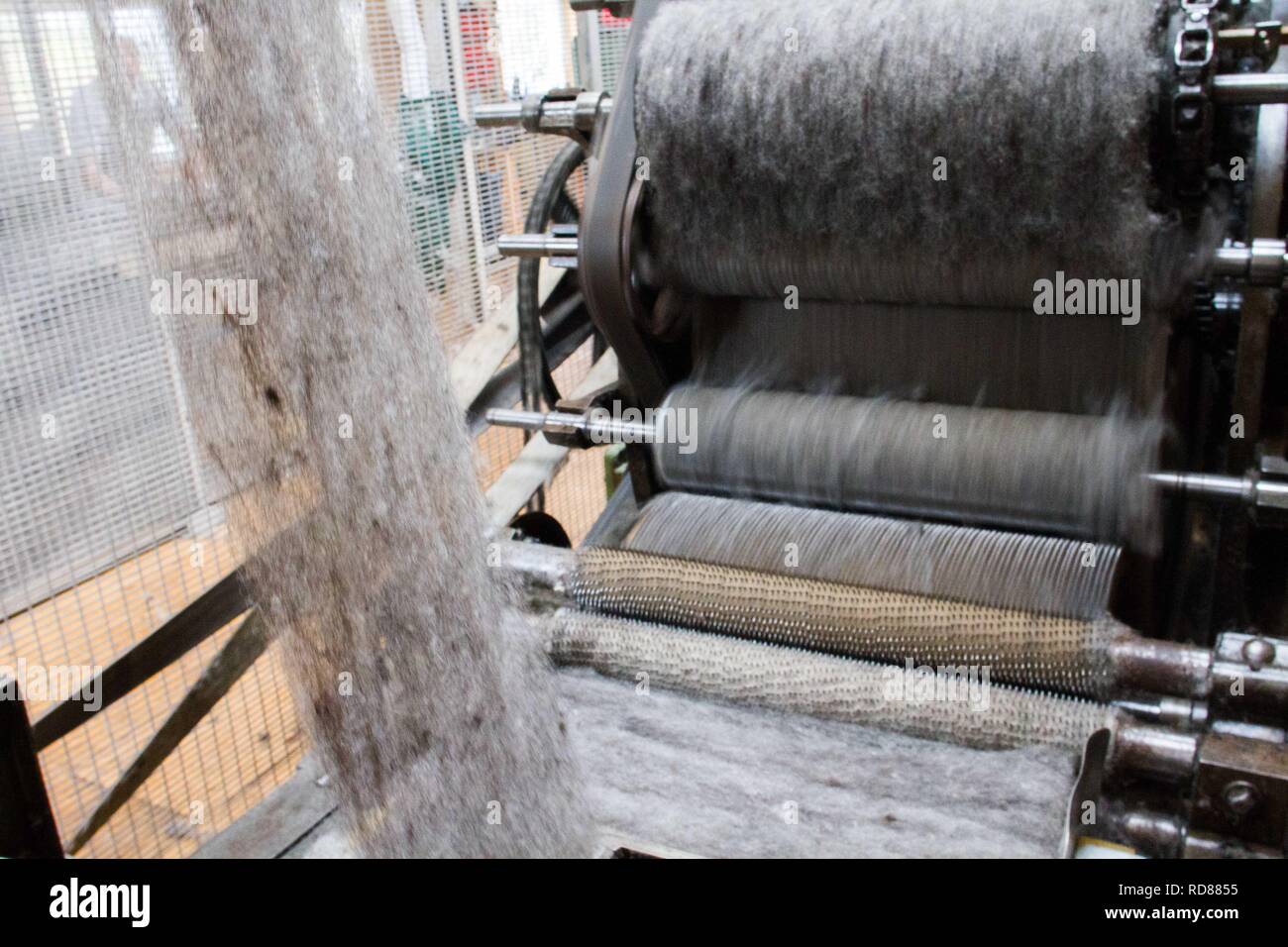 Wool thread being spun from raw wool product , part of process to ...