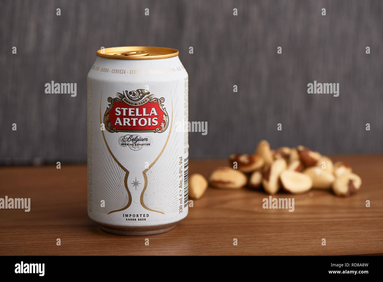 Gimpo, Korea - September 7, 2018: Stella Artois can, Belgian pilsner, on a wooden table with some Brazil nuts. Stock Photo
