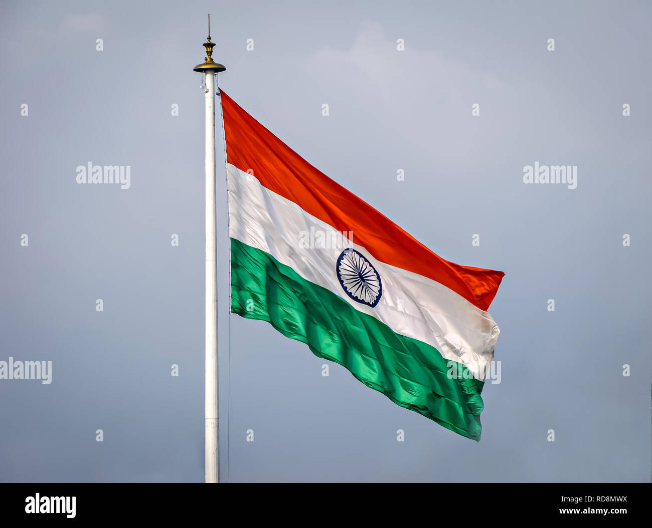 Gentle breeze, waving Indian National Flag on a clear background of blue sky. Stock Photo