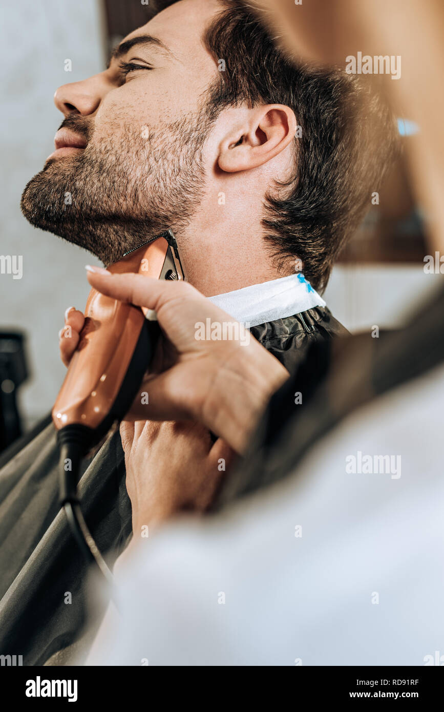 Close Up Partial View Of Hairdresser Using Electric Hair Trimmer