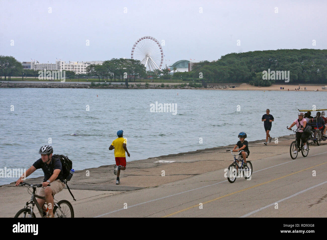 People jogging and riding bikes on Navy Pier in Chicago, IL, USA Stock Photo