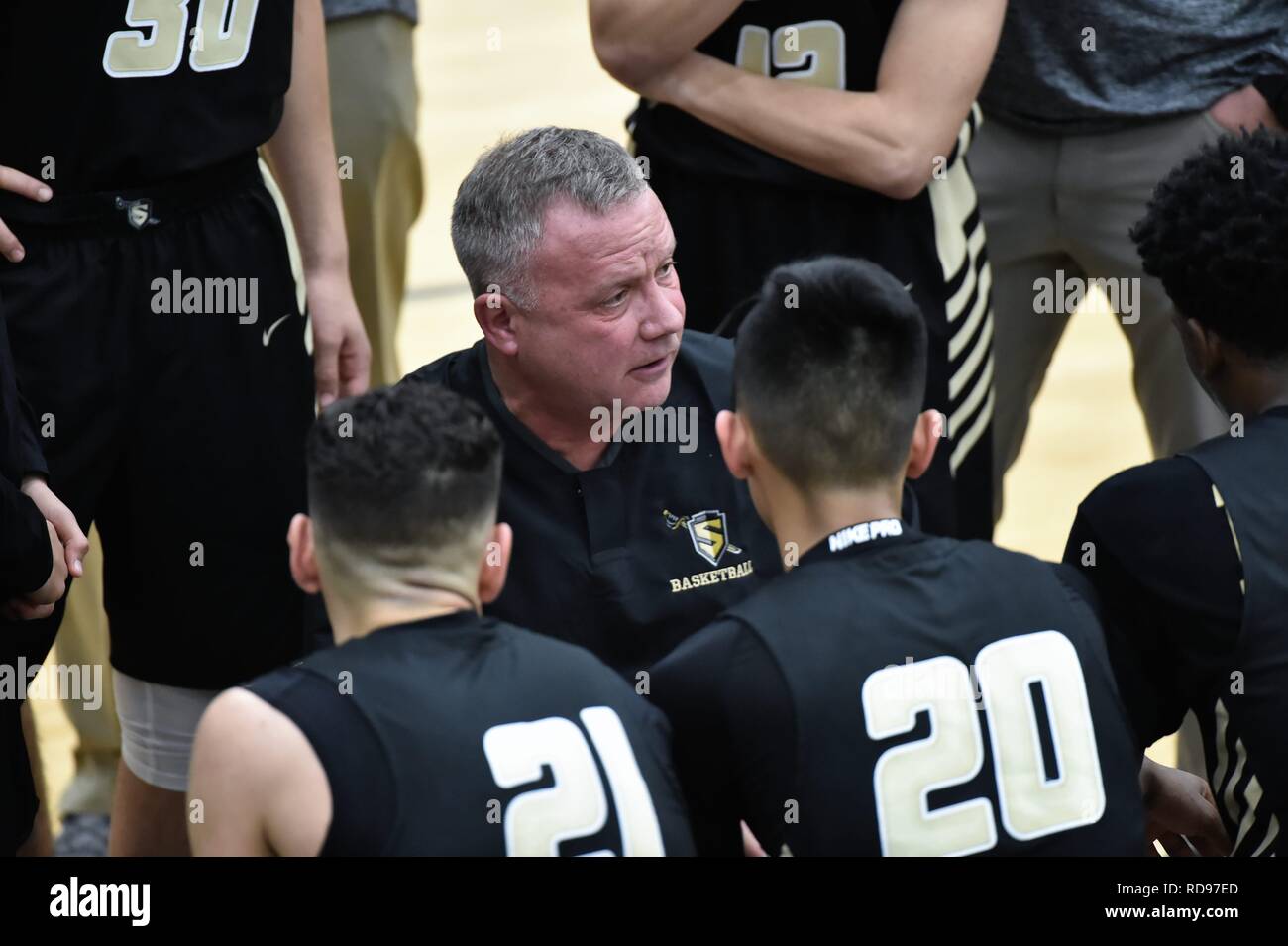 Bartlett, Illinois, USA. Coach providing instruction and strategy to his team during a time out. Stock Photo