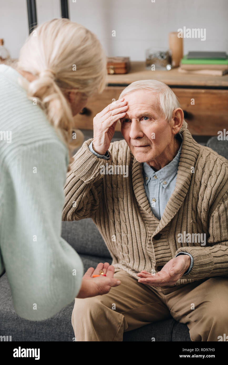 senior woman giving pills to old husband Stock Photo Alamy