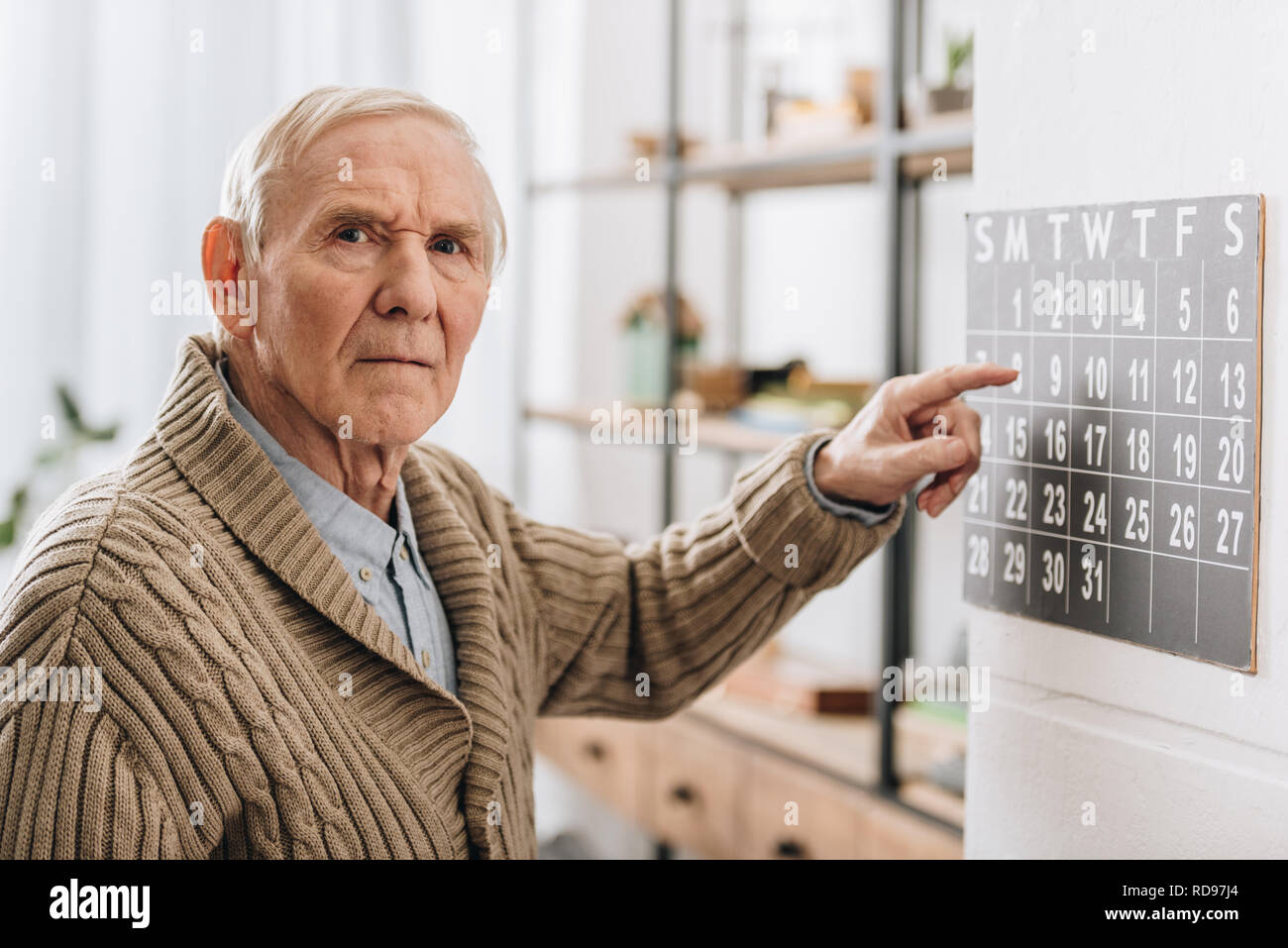 old man touching calendar looking at camera Stock Photo - Alamy