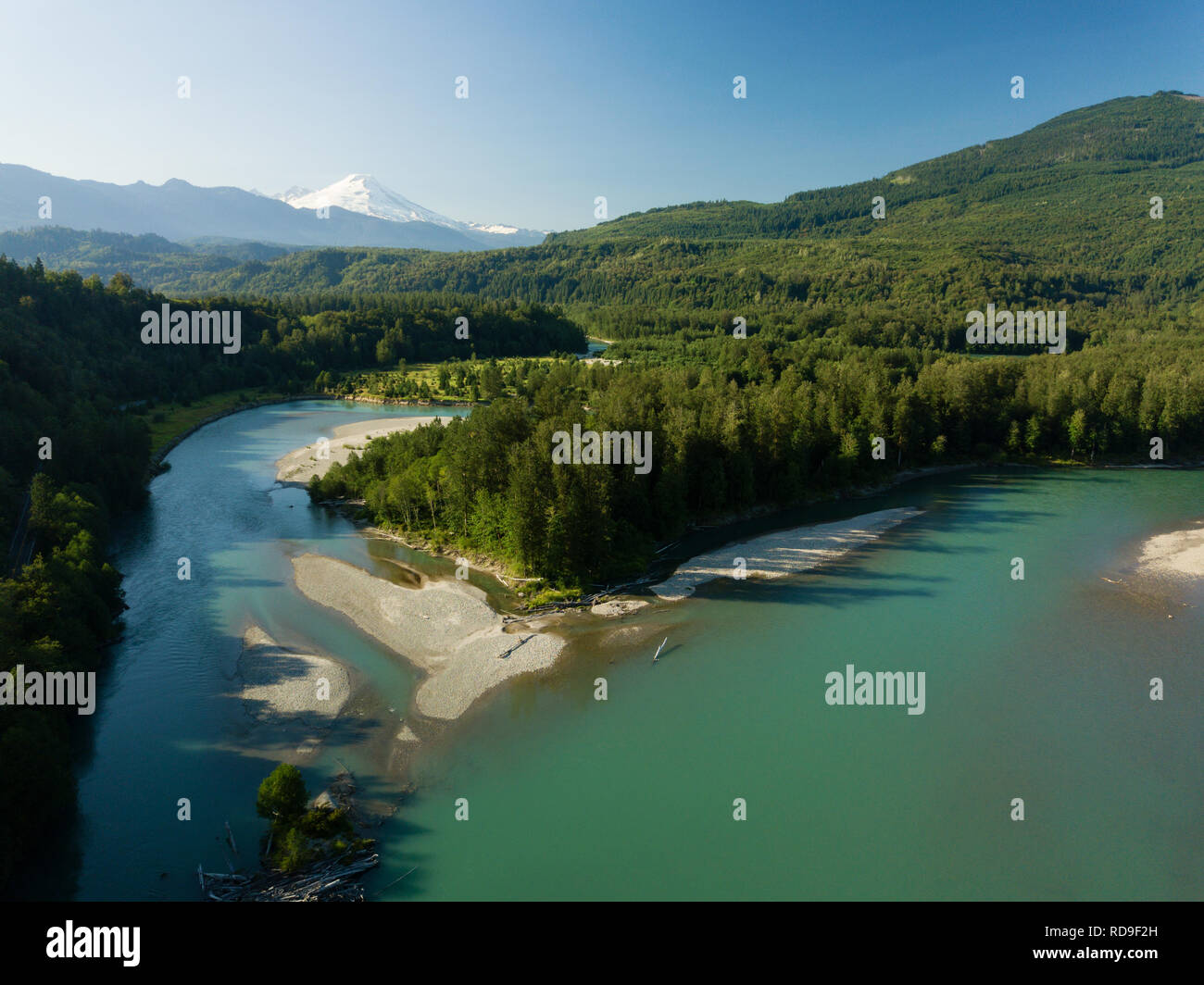 An aerial view of the Skagit River near Concrete, WA. Mt. Baker is in the background. Stock Photo