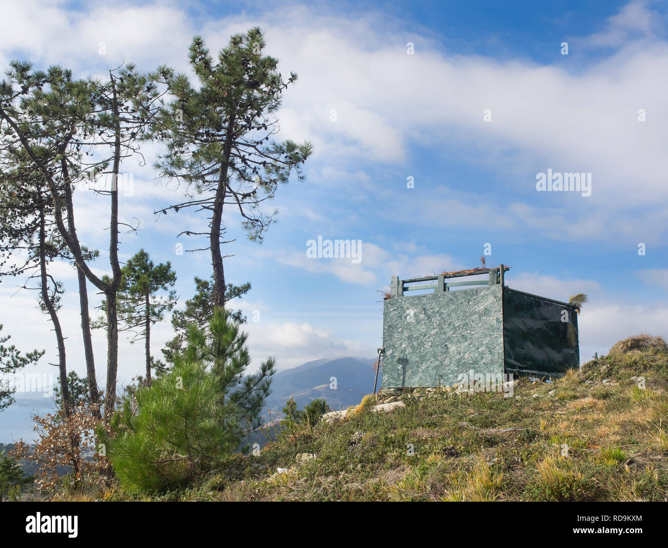 Hunting lodge camouflaged on top of a hill. hunters hide inside waiting for preys Stock Photo