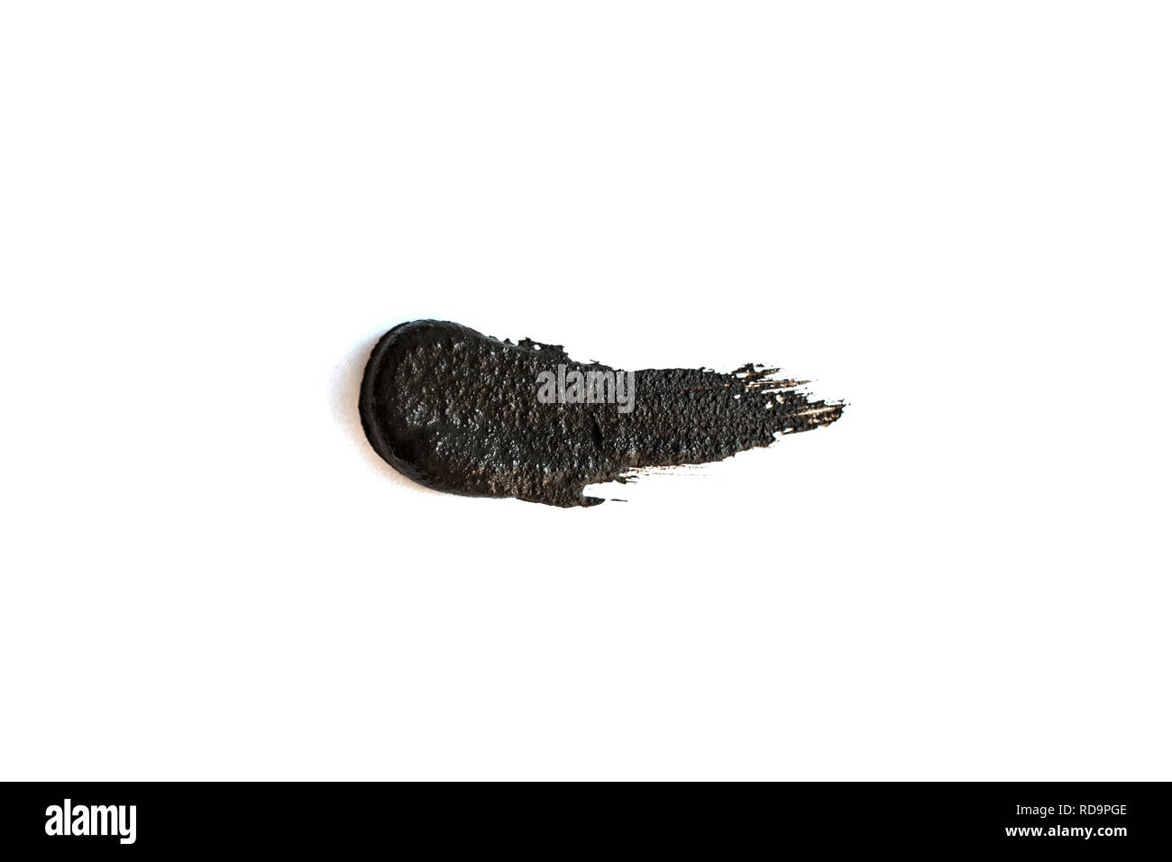 Black clay mask isolated on white background. Stock Photo