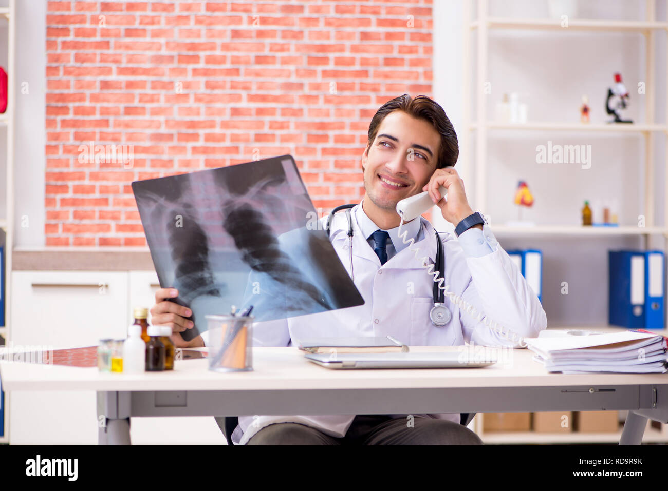Doctor checking xray talking young hi-res stock photography and images ...