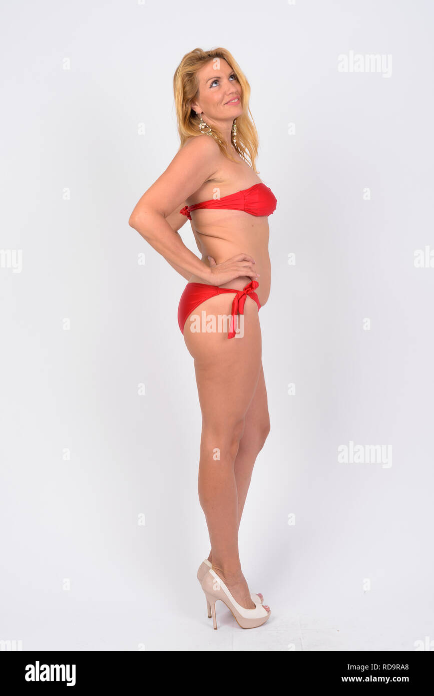 Full body shot of happy mature woman in bikini ready for vacation Stock Photo