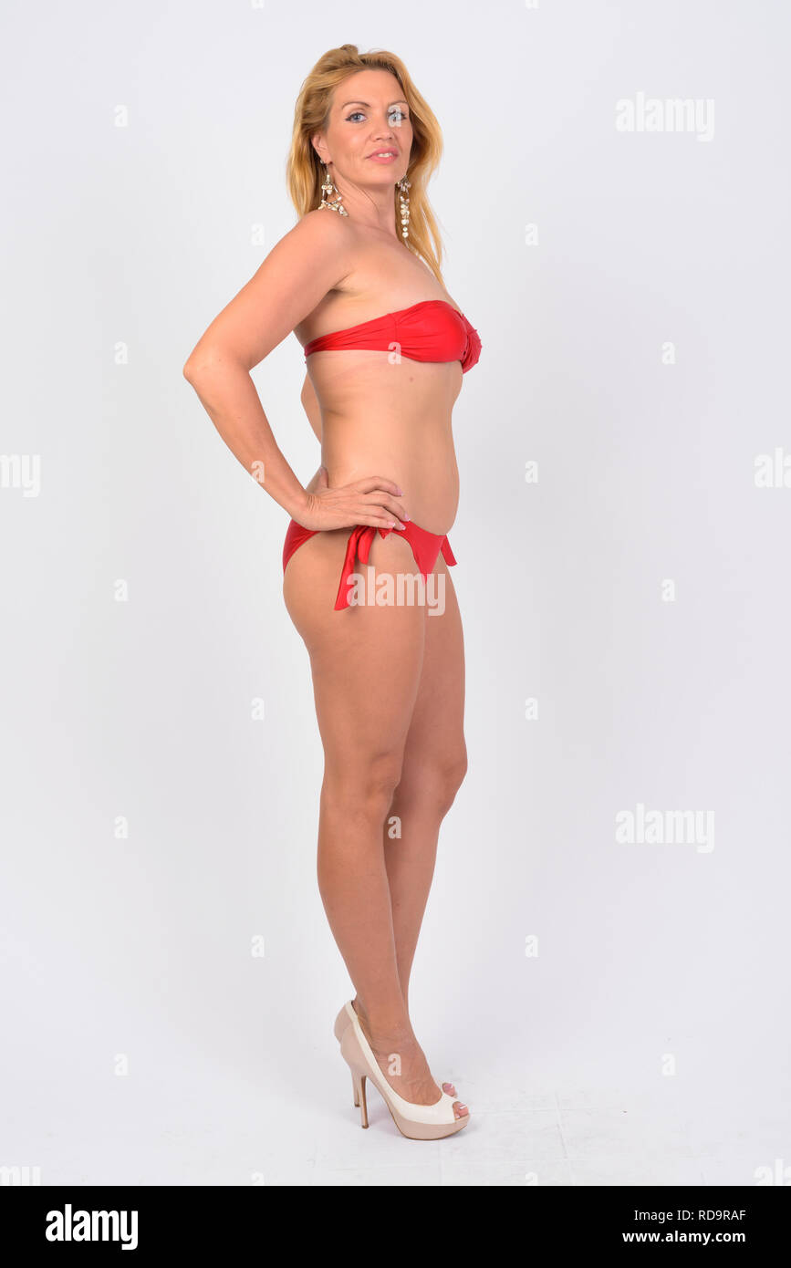 Full body shot of happy mature woman in bikini ready for vacation Stock Photo