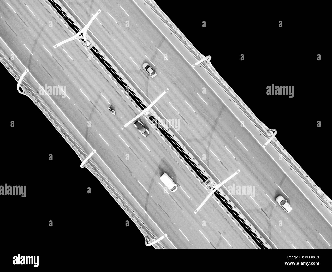Aerial view of highway in the ocean. Cars crossing bridge interchange