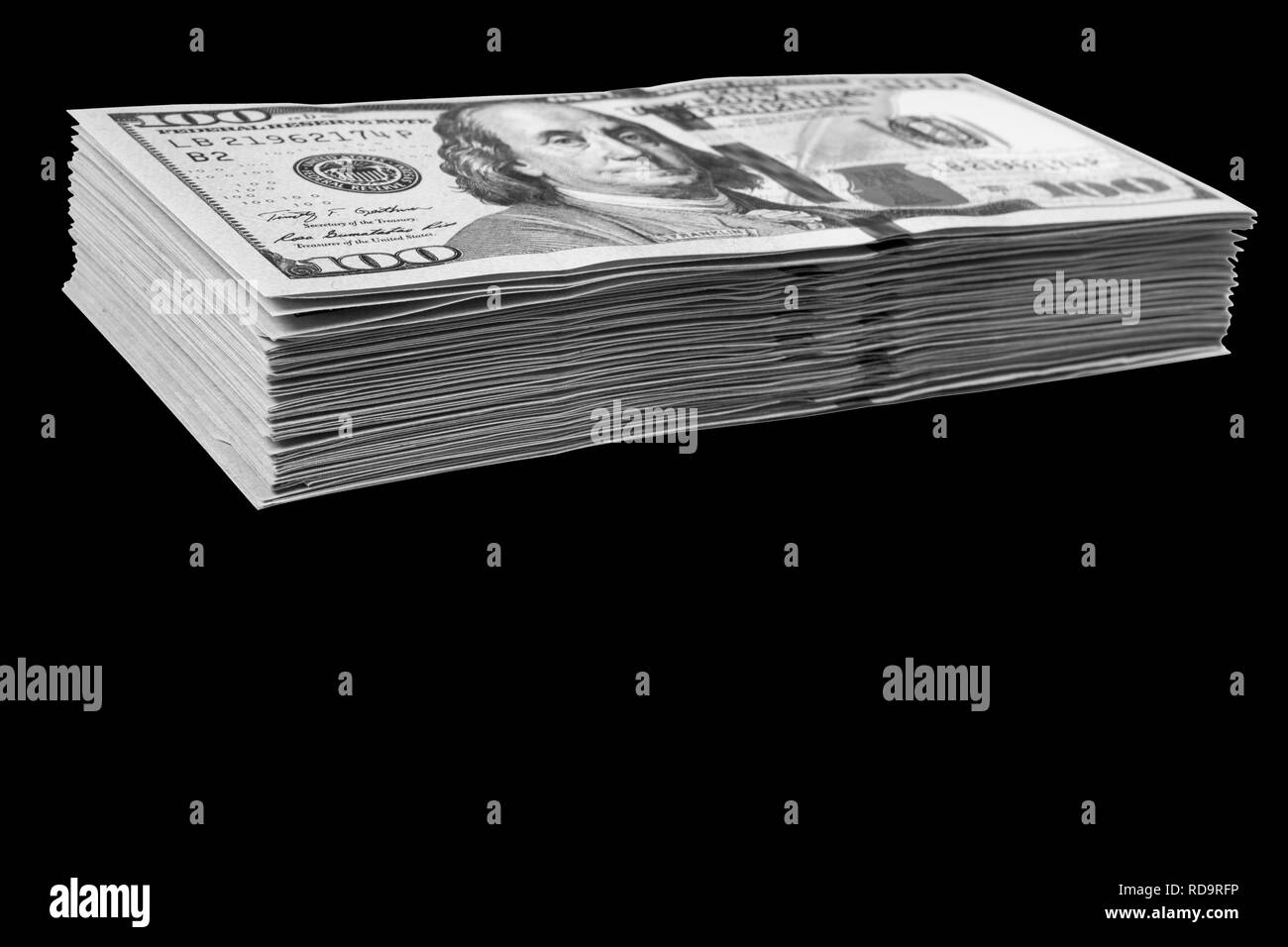 Stack of one hundred dollar bills isolated on black background. Stack of cash money in hundred dollar banknotes. Heap of hundred dollar bills backgrou Stock Photo