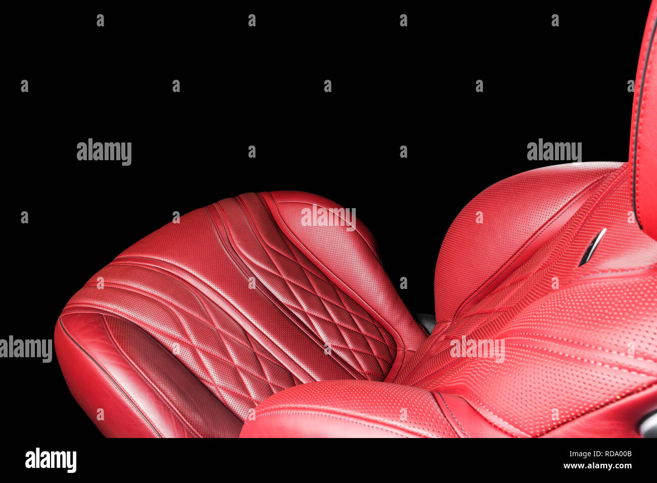 Red leather interior of the luxury modern car. Perforated red leather