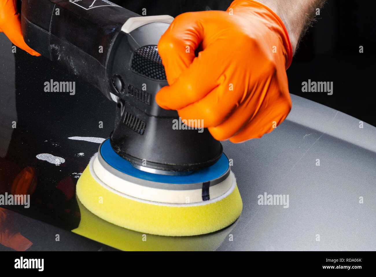 Car polish wax worker hands applying protective tape before polishing.  Buffing and polishing car. Car detailing. Man holds a polisher in the hand  and Stock Photo - Alamy