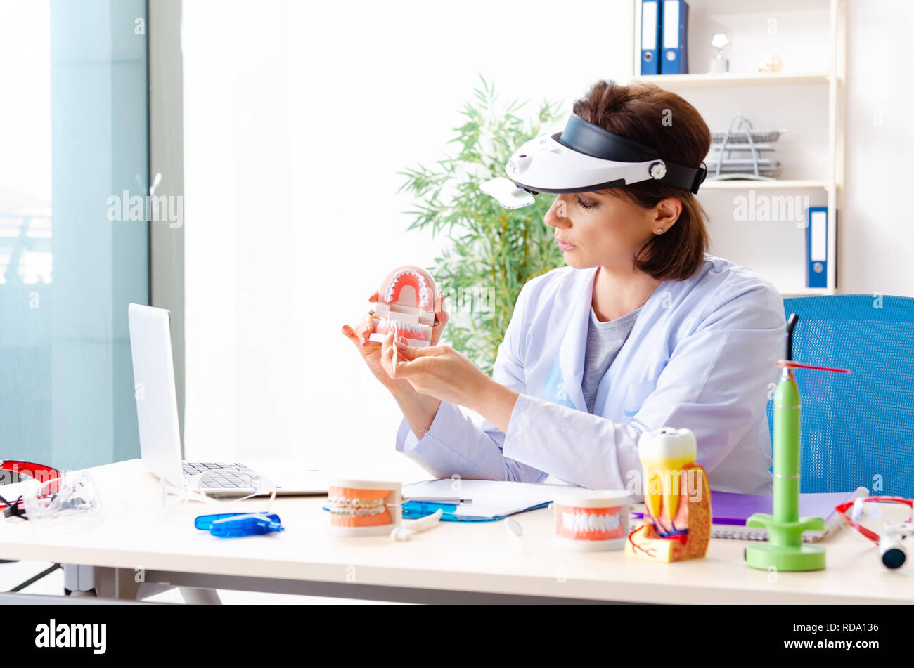 Female doctor working on new teeth implant Stock Photo